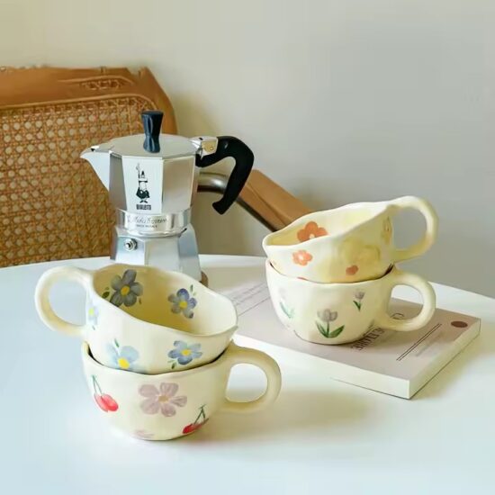 Hand-painted ceramic coffee mug with embossed floral pattern and vintage look