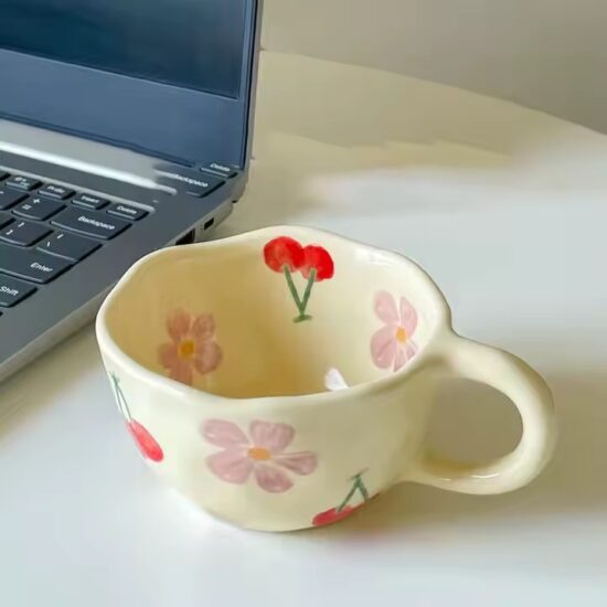 Hand-painted ceramic coffee mug with embossed floral pattern and vintage look