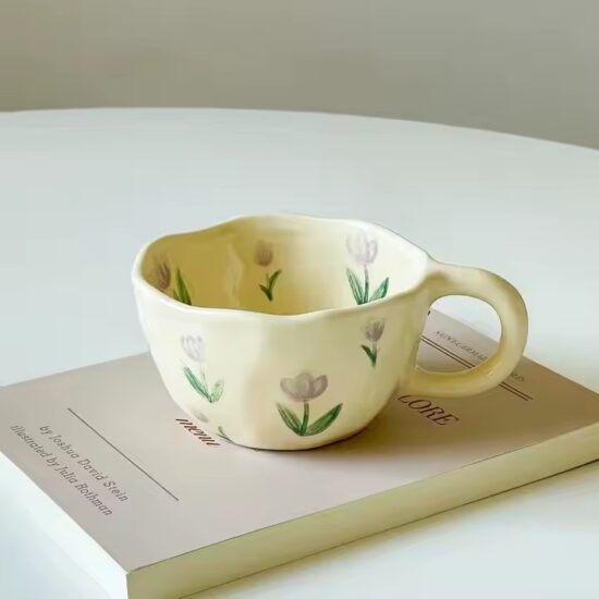 Hand-painted ceramic coffee mug with embossed floral pattern and vintage look