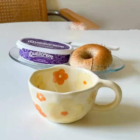 Hand-painted ceramic coffee mug with embossed floral pattern and vintage look