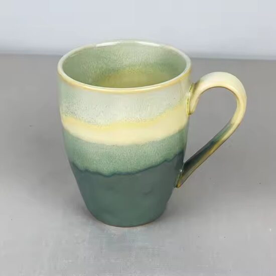 Modern ceramic coffee cup with glossy finish and ergonomic handle design